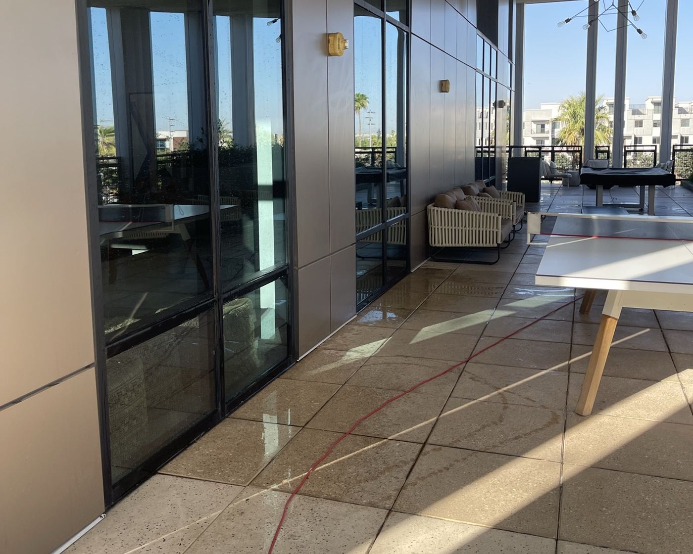 Tall glass doors and a freshly washed deck at a Phoenix home
