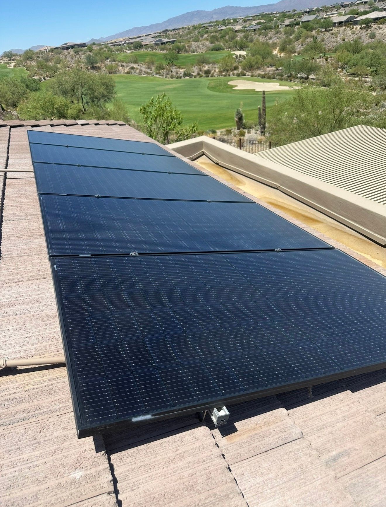 A roof-mounted solar array after cleaning, cells sharp and dark