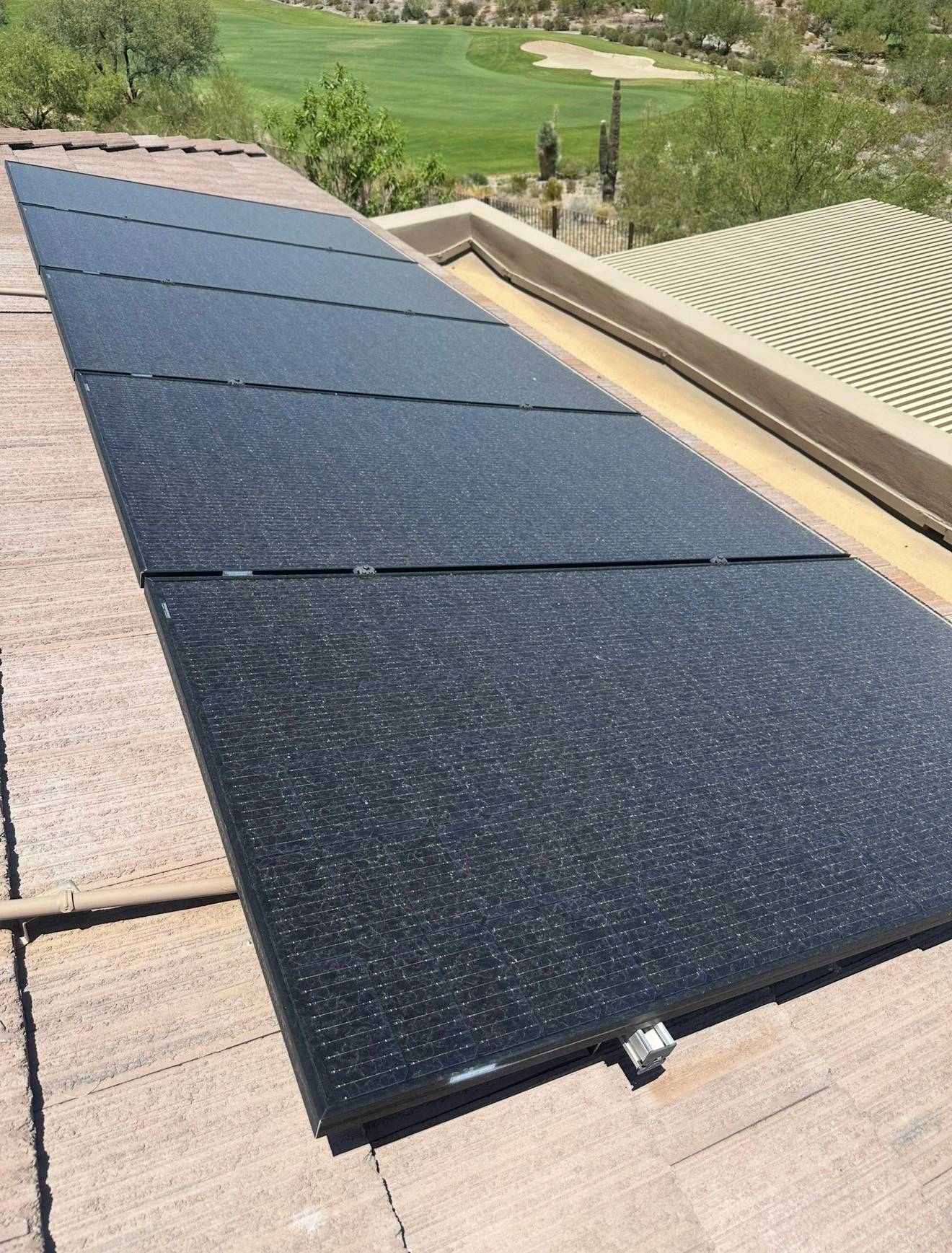 A roof-mounted solar array before cleaning, dulled by Valley dust