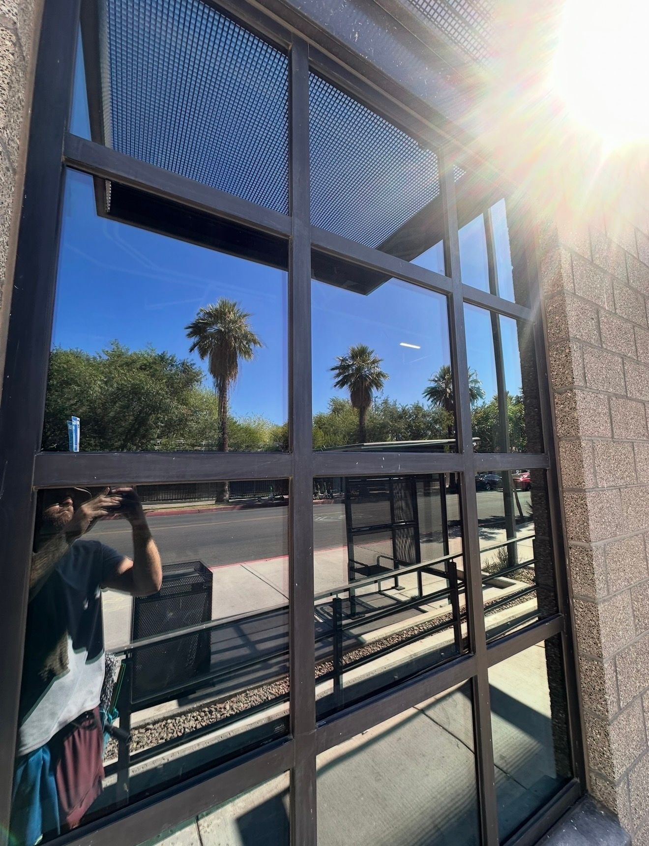 The same storefront window after cleaning, reflections sharp and frames wiped